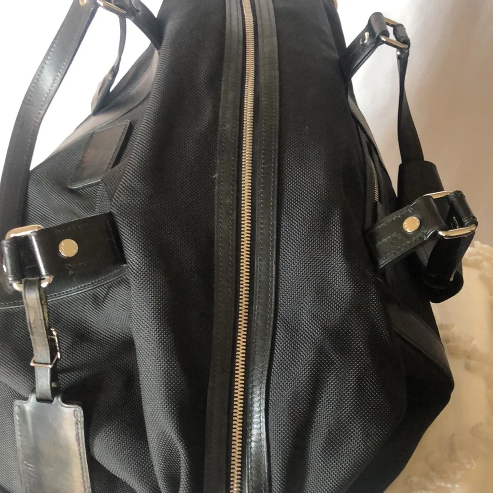 TUMI black Boston 2 way leather and canvas and mini lock. Detachable straps.
